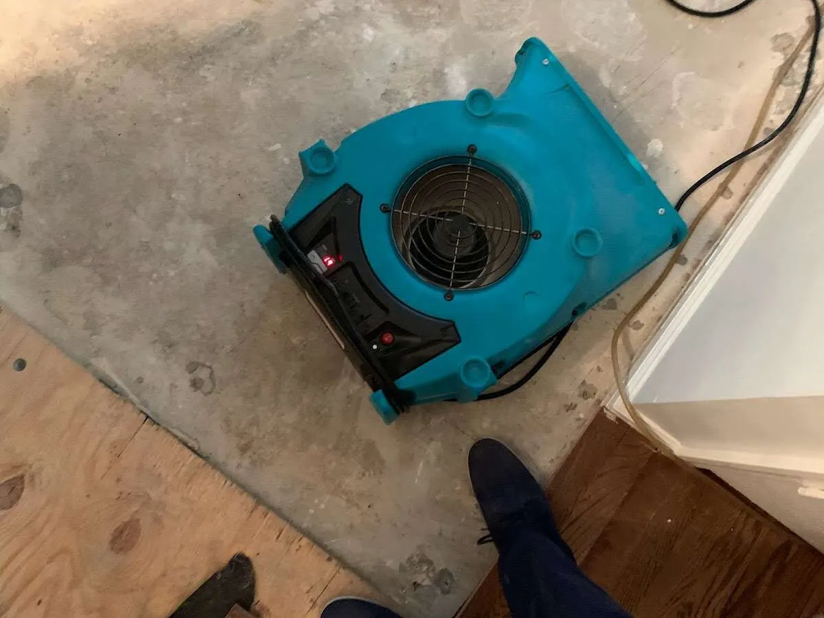 Air mover drying subfloor during Commercial Water Damage Restoration in West Perrine